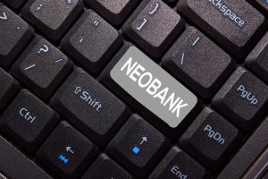 A close-up of a black computer keyboard with a special gray key that has the word "NEOBANK" written on it. The image symbolizes the digital-first nature of neobanks, which is the central topic of the article.