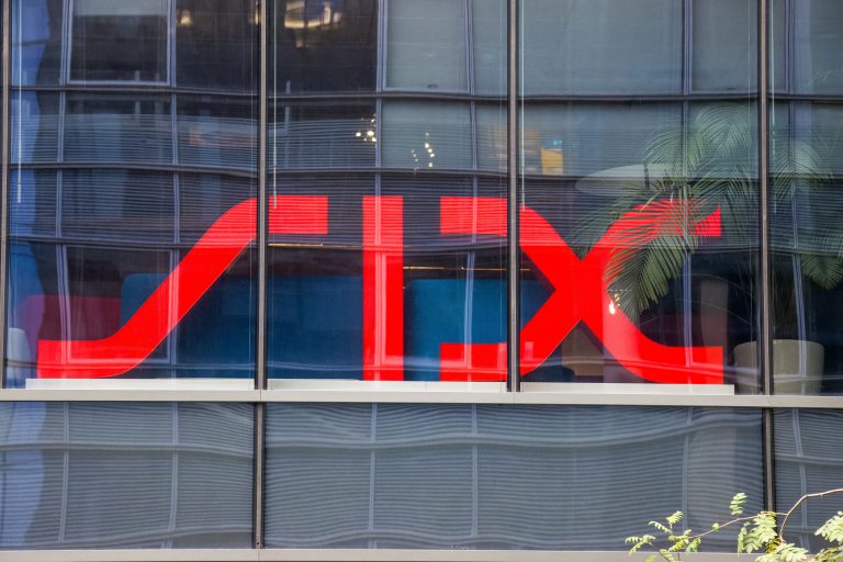 The red SIX Group logo prominently displayed on the glass window of a modern office building.