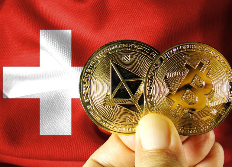 A hand holding gold Bitcoin and Ethereum coins against a background of the Swiss flag.